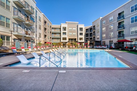 A swimming pool surrounded by apartment buildings.