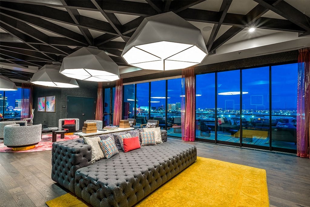 a living room with a couch and a view of a city at night