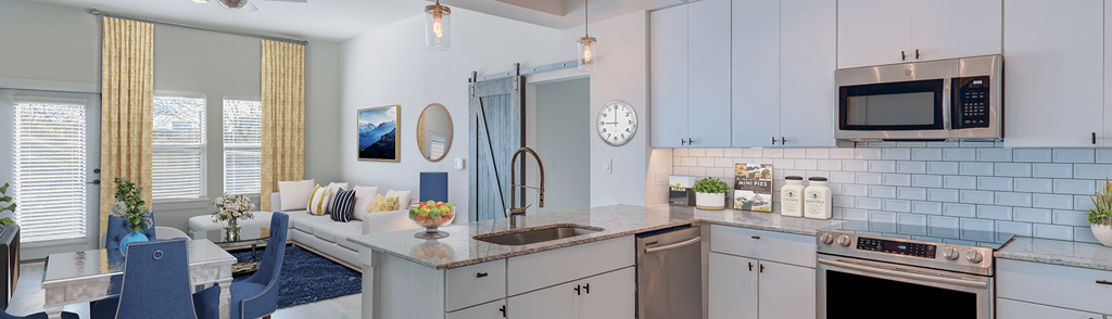 a kitchen with white cabinets and a sink and a microwave