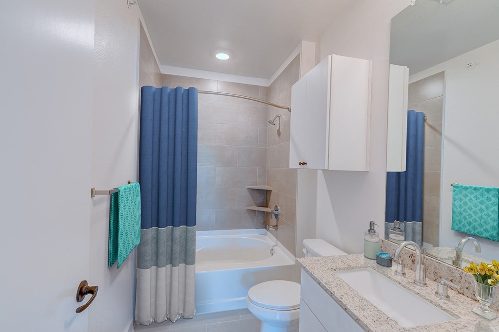 a bathroom with a sink toilet and a tub