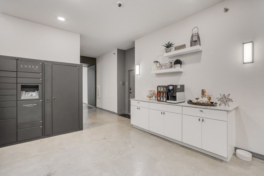 a kitchen with white cabinets and a stainless steel refrigerator