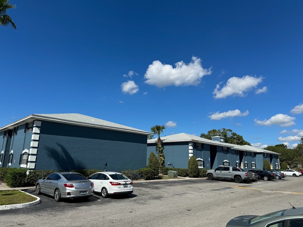 The Marley at Trout River Apartments in Jacksonville, FL 32218 photo of a blue building with cars parked in a parking lot
