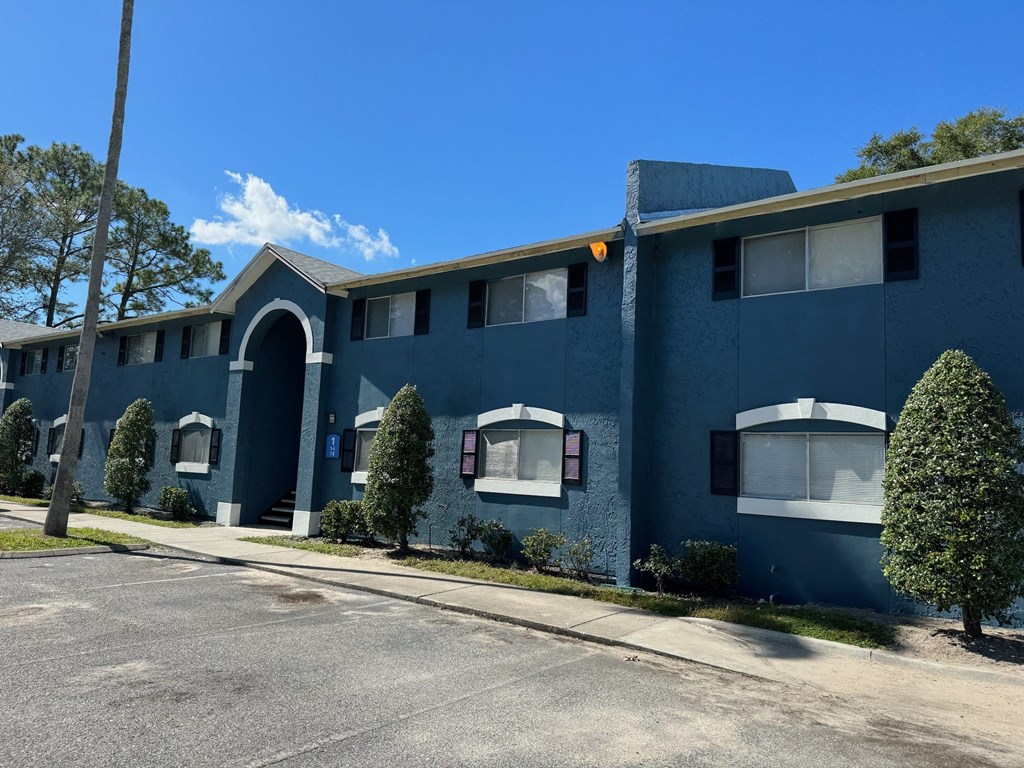 The Marley at Trout River Apartments in Jacksonville, FL 32218 photo of a blue building with a street in front of it