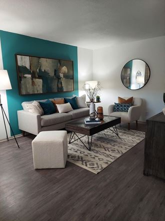 a living room with a turquoise accent wall
