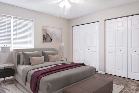 A bedroom with a large bed and a painting on the wall.