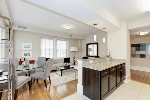 A modern kitchen with a dining table and chairs.