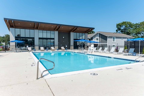A large swimming pool with a building in the background.