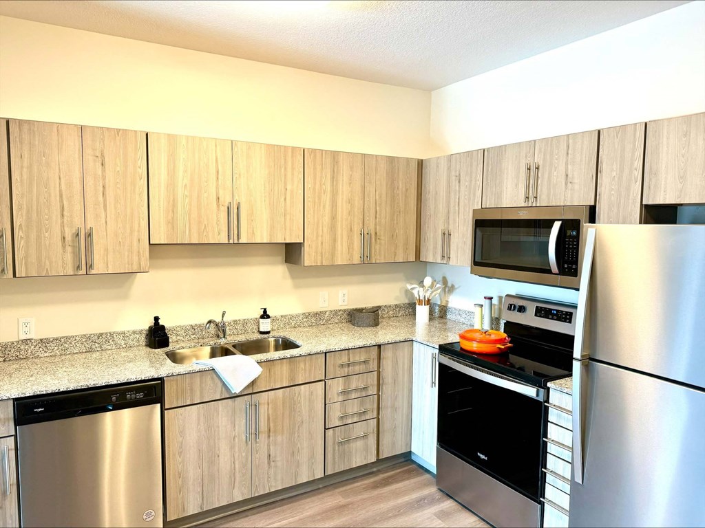 a kitchen with stainless steel appliances and wooden cabinets