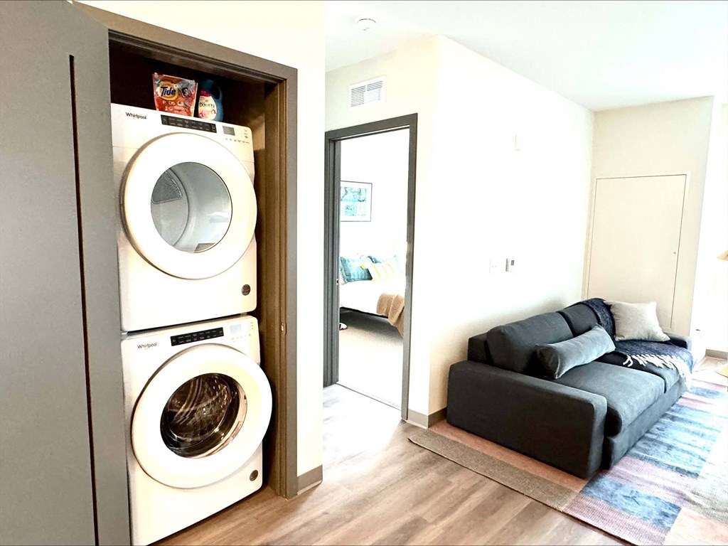 a laundry room with a washing machine and a couch