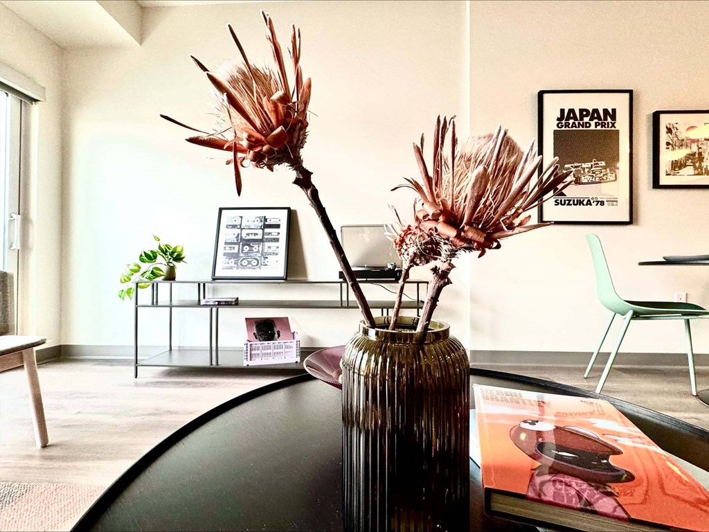 a vase with flowers on a table in a living room