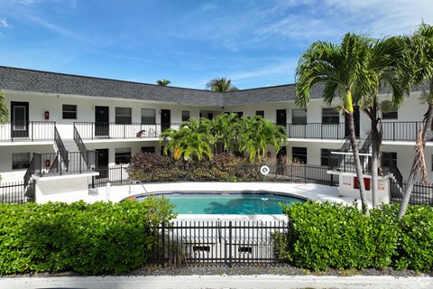 Swimming pool at RTW Rentals in Fort Lauderdale featuring tropical landscaping, outdoor seating areas, and relaxing community gathering spaces.