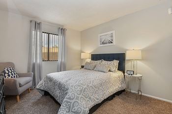 a bedroom with a bed and a chair
