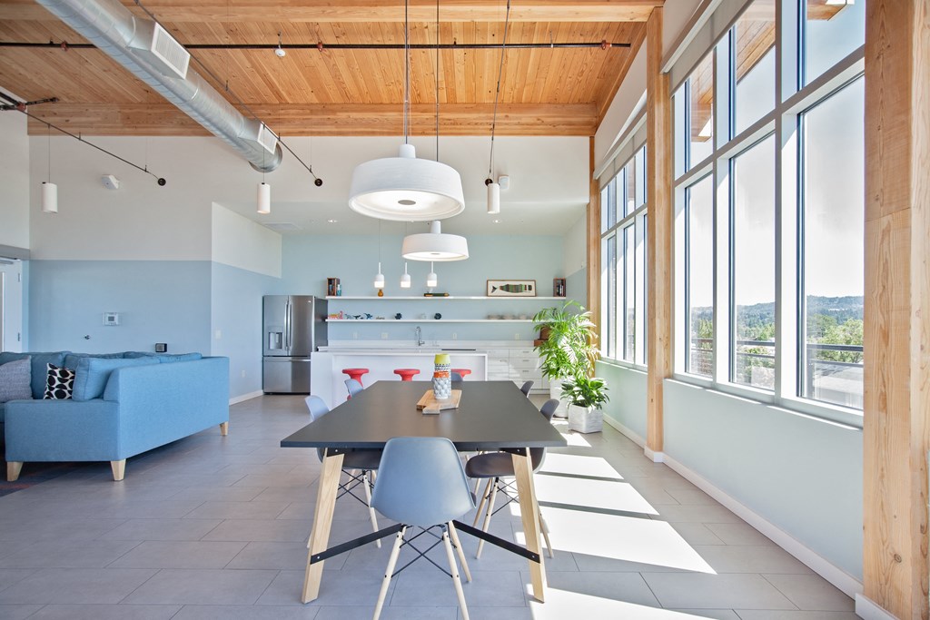 a dining room with a table and chairs in front of a window with a view of a