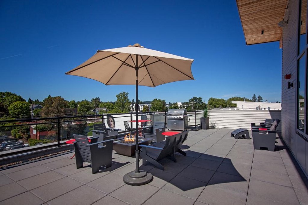 Beaverton, OR, Apartments - Westline - Relaxing Rooftop Lounge with Fire Pit, Grill Station, Cozy Seating, And Umbrella