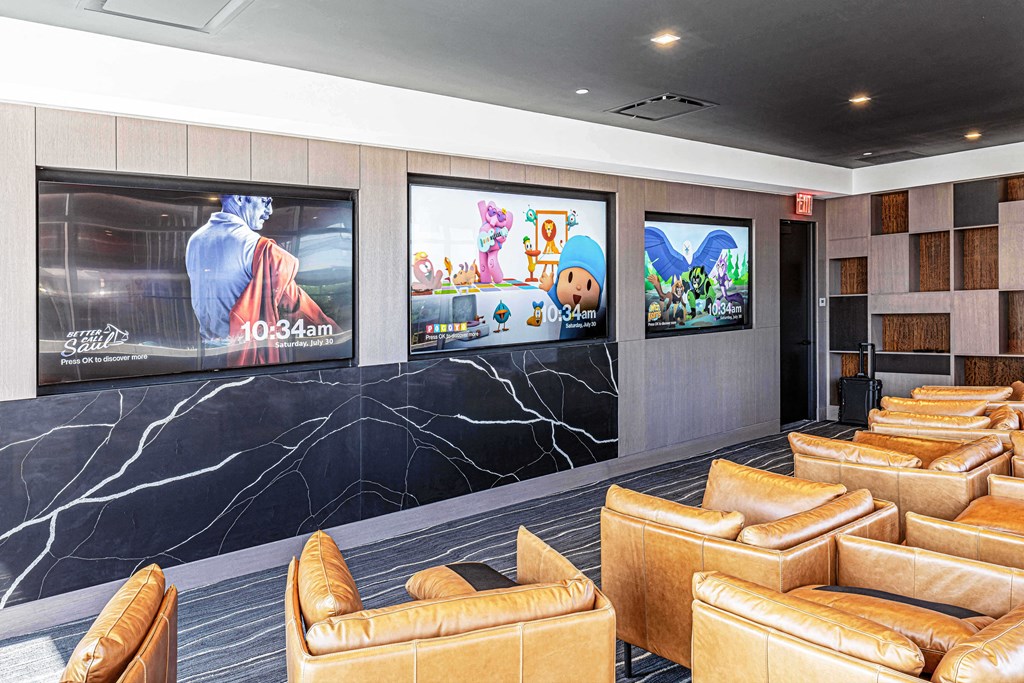 3thirty3 new rochelle ny apartment high rise photo of media room with leather club chairs and multiple televisions TVs and modern accents