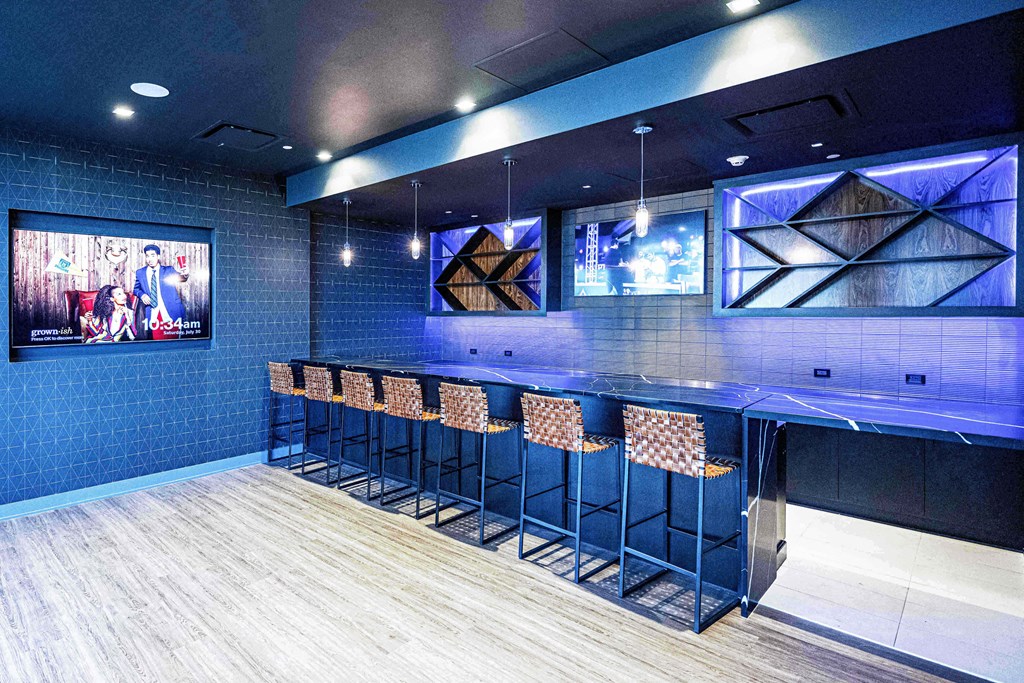 3thirty3 new rochelle ny apartment high rise photo of sports pub area with bar seating and multiple televisions TVs and modern furniture and lighting