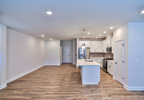 a kitchen with white cabinets and a white counter top