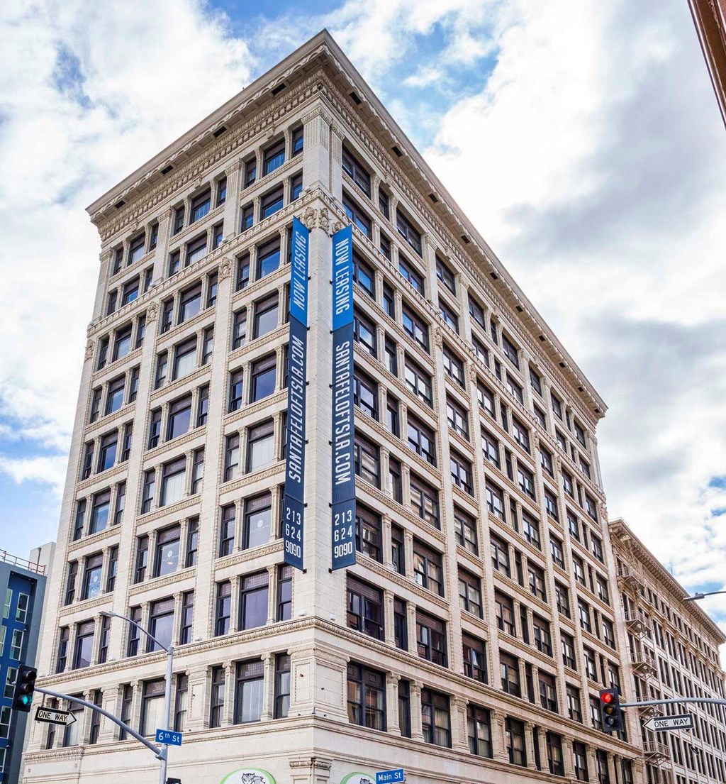 a tall building with a blue sign on the side of it