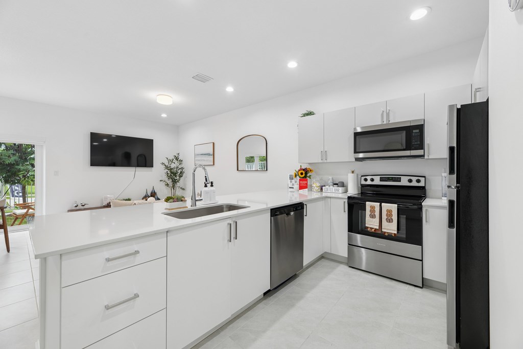 Luxury kitchen with stainless steel appliances Pearl at Pompano Townhomes in Pompano Beach, FL