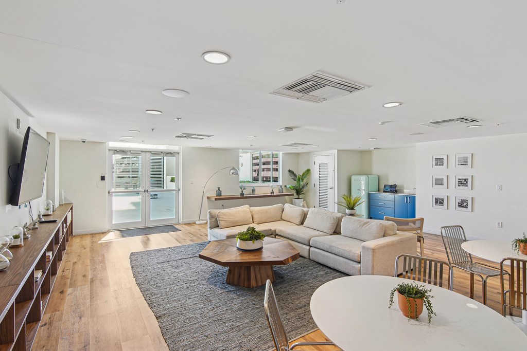Apartments for Rent in Riverview Miami, FL– Riverview One Apartments -   Clubhouse seating area with a white coffee table and a grey rug.