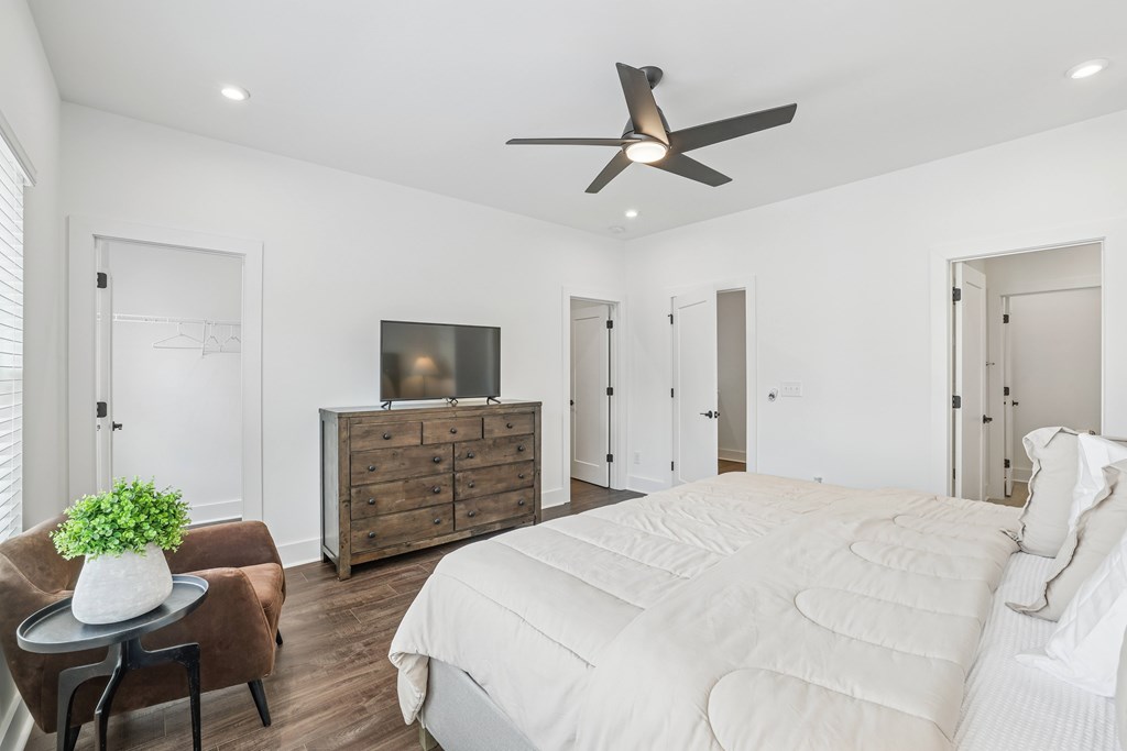 Spacious bedroom with two windows and a ceiling fan in pet-friendly townhomes at Henley Avondale in Avondale Estates, GA.