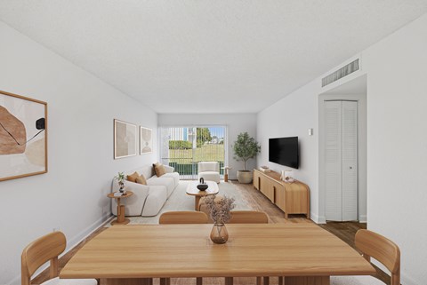 A dining room with a wooden table and chairs.