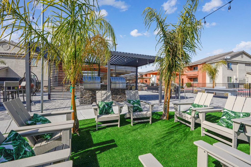 A sunny day at the outdoor seating area with green grass and trees.