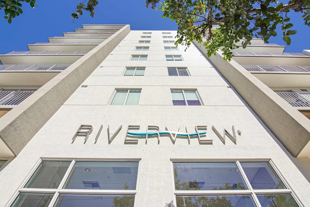 1- & 2-Bedroom Apartments for Rent in Miami, FL – Riverview One Apartments – A white building with the word "RIVERVIEW" on the side.