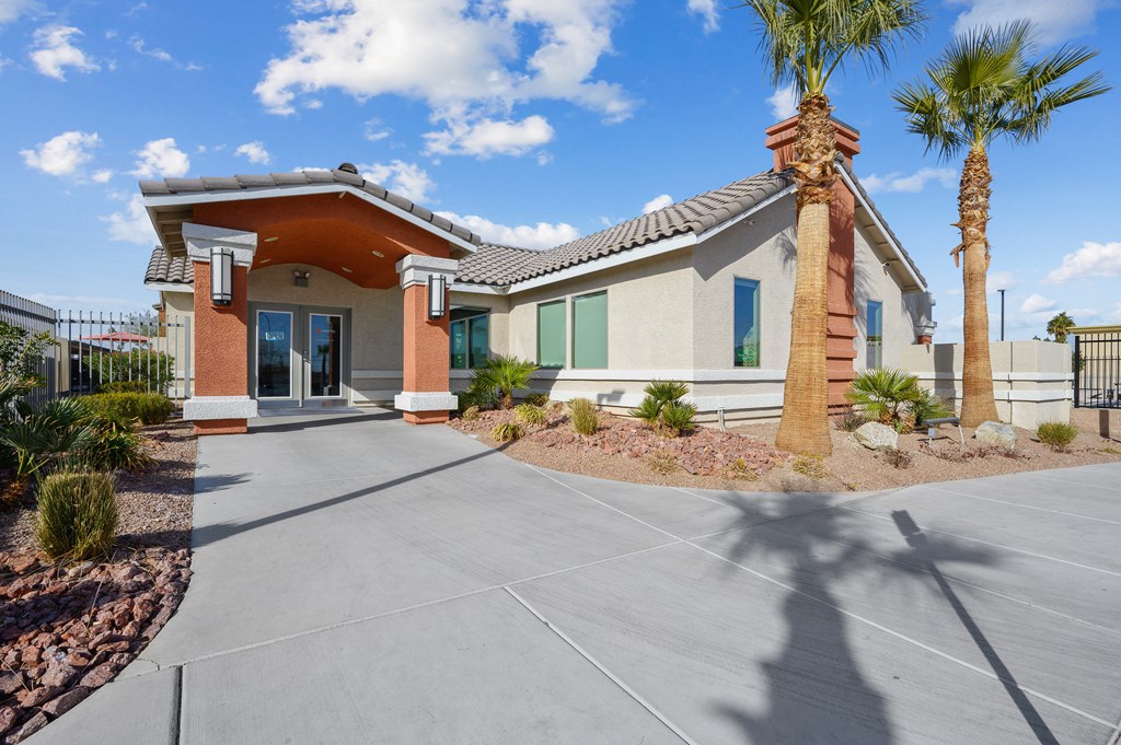 A house with a palm tree in front.