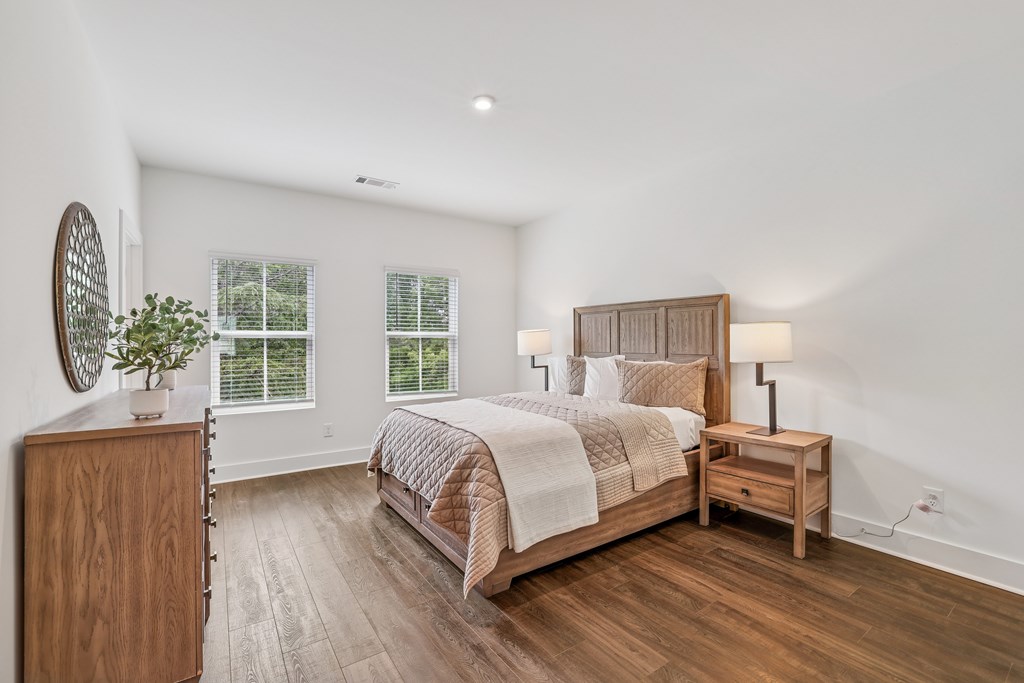Spacious bedroom with two windows in pet-friendly townhomes at Henley Avondale in Avondale Estates, GA.