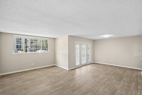 A room with a window and sliding glass doors.