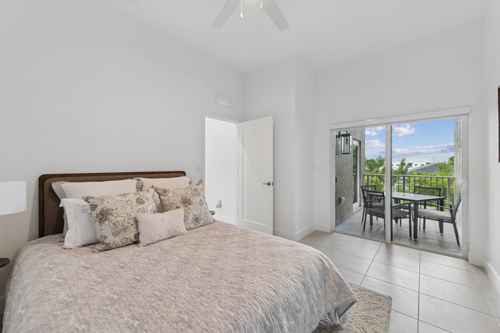 Pearl at Pompano Beach Townhomes in Pompano Beach, FL bedroom with patio and connected bathroom