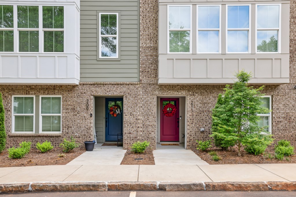 A house with a red door and a wreath on it.