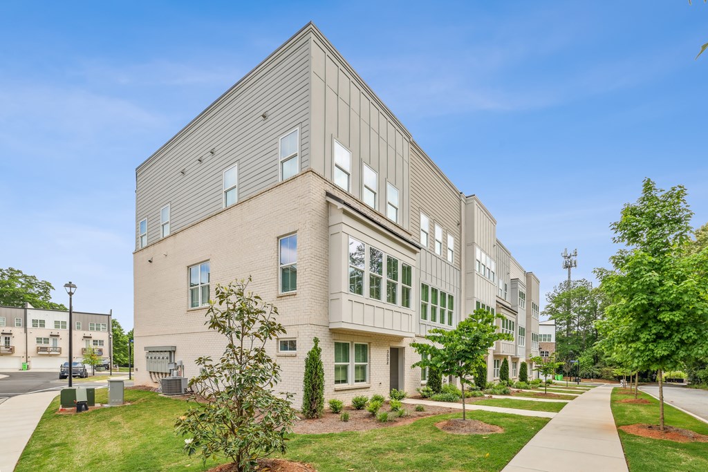 A modern building with a grey facade and large windows.