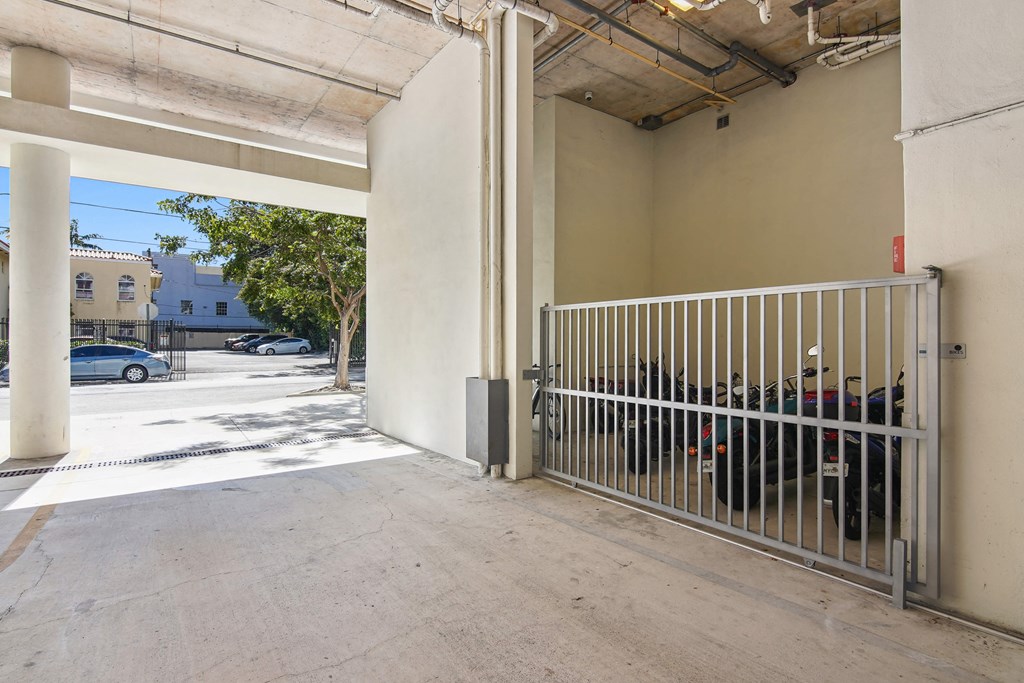 Apartments for Rent in Riverview Miami, FL– Riverview One Apartments -   A parking garage with a gate and a wall.