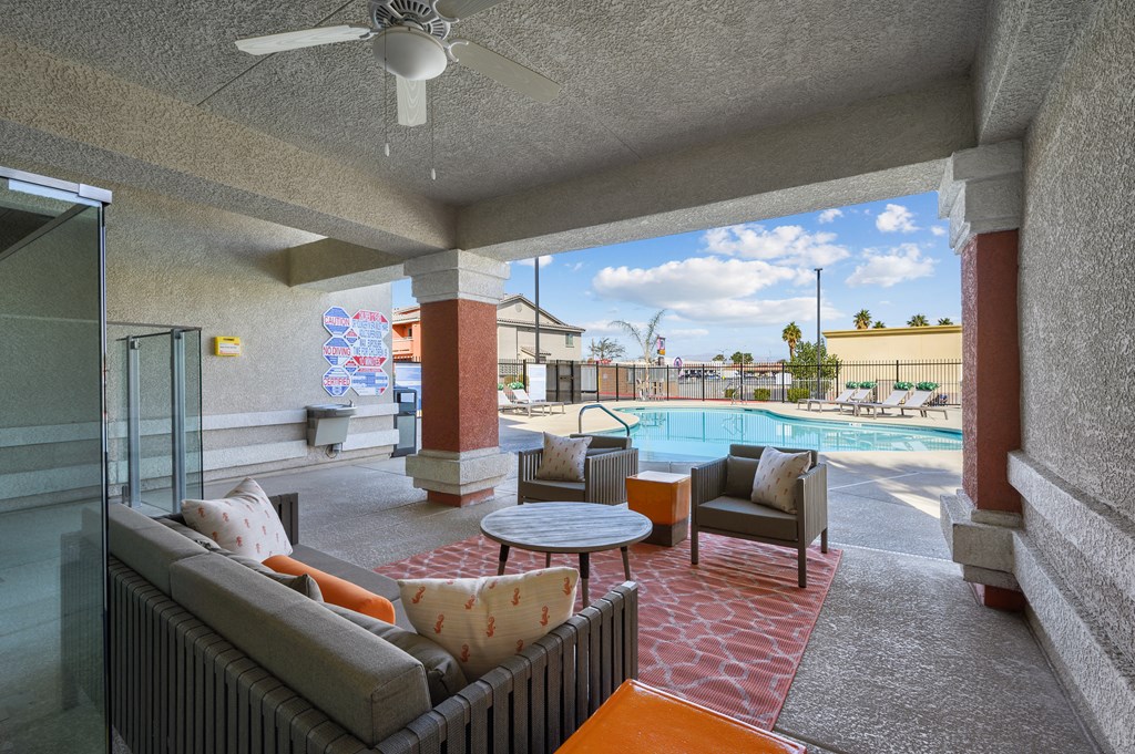 A patio with a pool table and chairs.