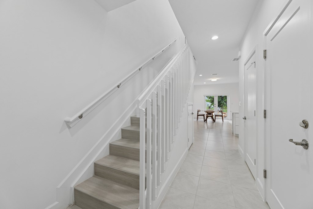 Pearl at Pompano Beach townhomes in Pompano Beach, FL  hallway with a staircase and a door on the right.