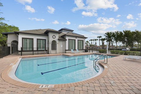 A small pool in front of a house.
