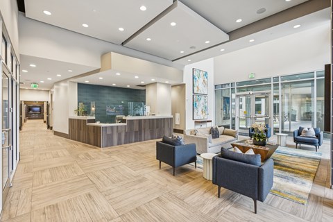 A spacious office lobby with a reception desk and comfortable seating areas.