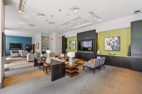 A modern living room with a grey sofa and a wooden coffee table.