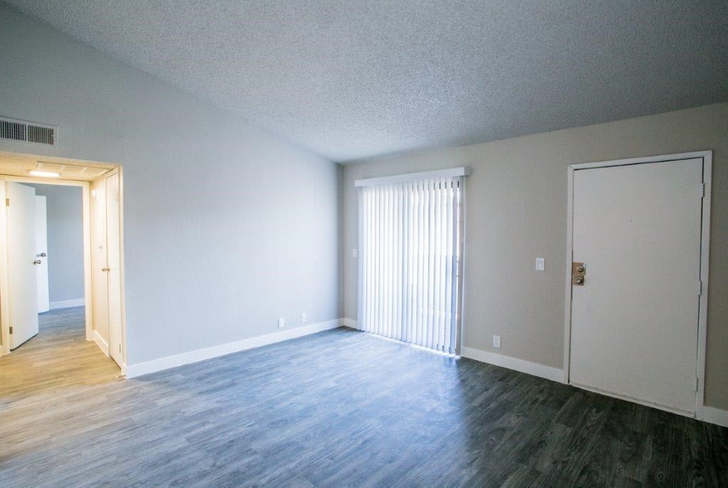 an empty living room with a white door