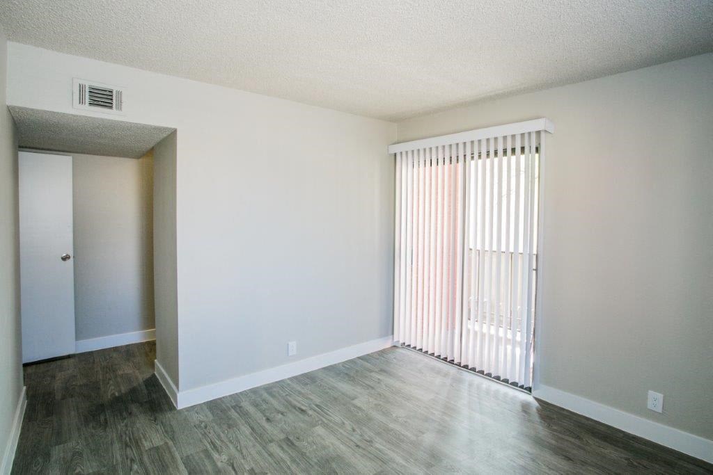 an empty living room with a sliding glass door