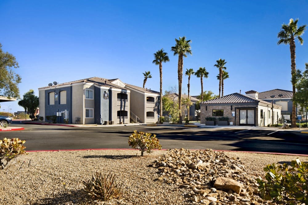a house on a street with palm trees in the background