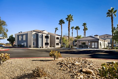 a house on a street with palm trees in the background