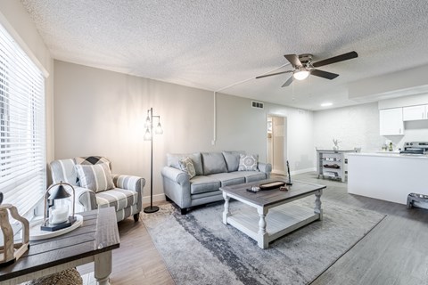 A living room with a grey couch and a coffee table.