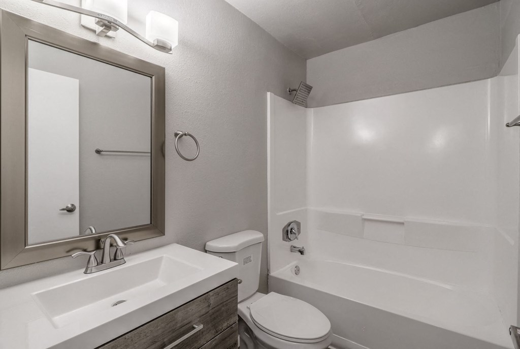 Bathroom with tub, shower, and mirror at Sono Tempe, a pet-friendly community in Tempe near downtown Tempe, AZ.