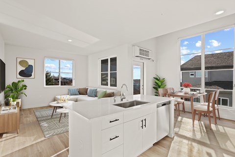 A modern kitchen with white cabinets and a large island.