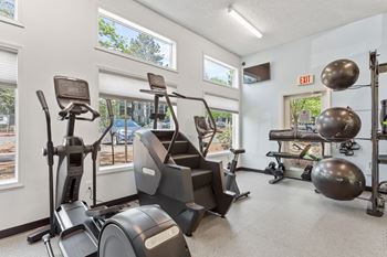 A gym with treadmills, exercise balls, and weight machines. at Cedar Crest, Beaverton