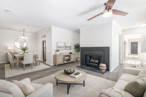 A modern living room with a fireplace and a dining area.