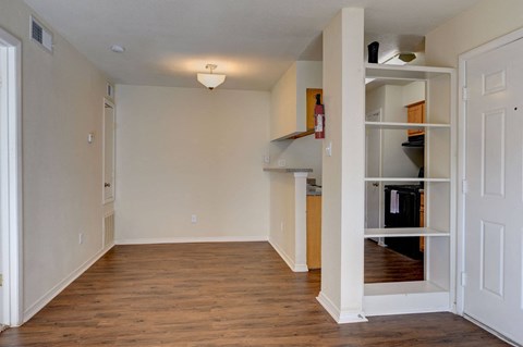 A room with a white door and a white shelf with items on it.